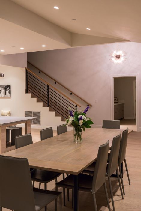 Modern dining room with recessed ceiling lights and pendant fixture