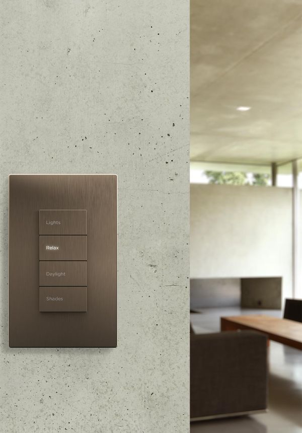 Wall-mounted lighting keypad with scene buttons in a modern living room